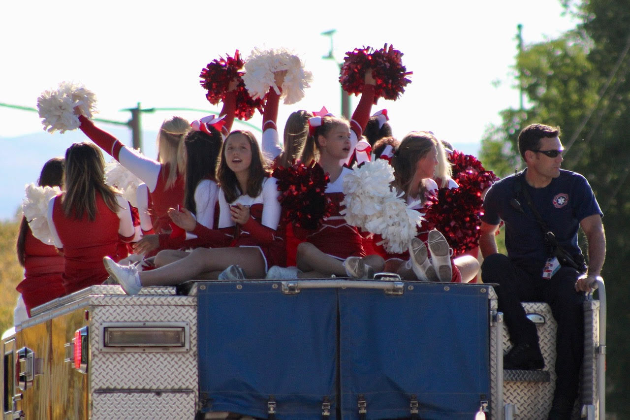 The Montrose High School cheer team’s members perch atop a fire truck